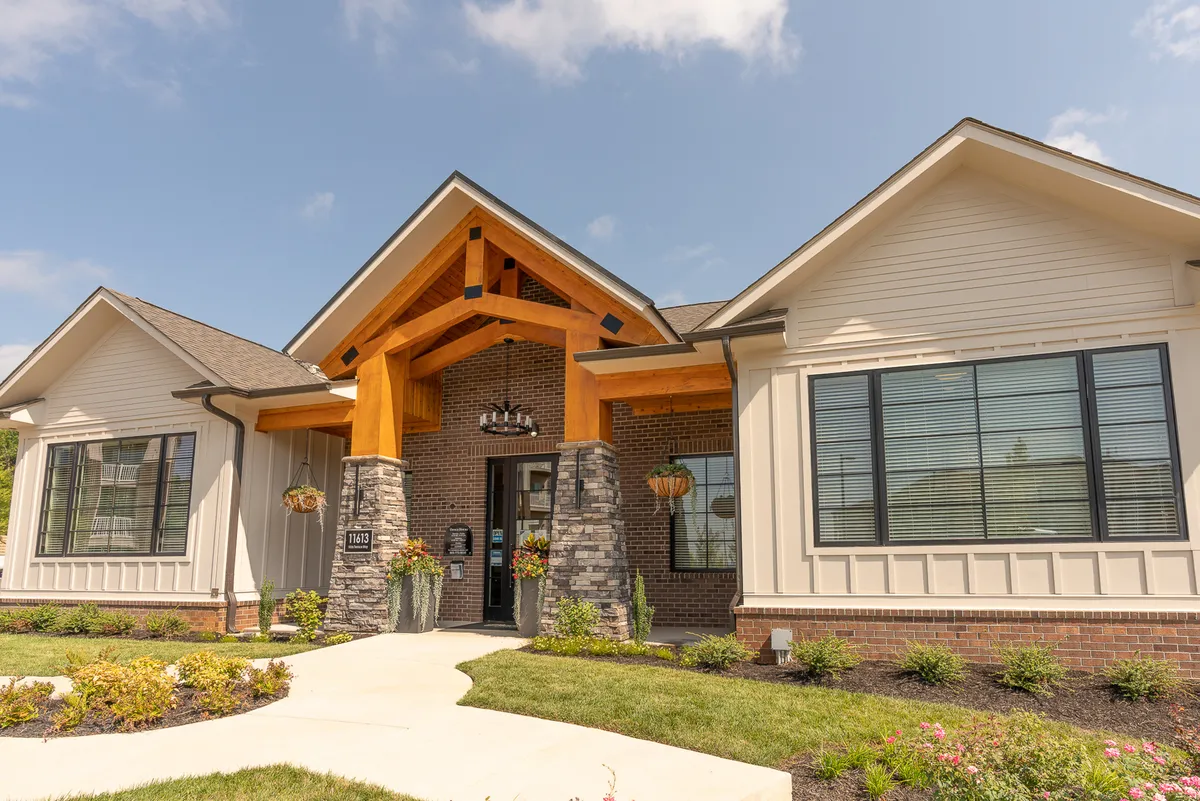 This image features the Overlook at Farragut’s main exterior entrance framed by a wooden entryway, sturdy stone columns, and a beautifully landscaped garden. Large windows give a glimpse into the interior, and the entry area is designed to feel welcoming for visitors and residents alike.